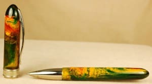 Colorful resin pen with cap on display.