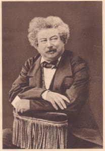 Man with curly hair and formal attire.