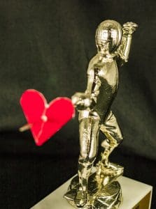 Golden statue with heart-shaped arrow.