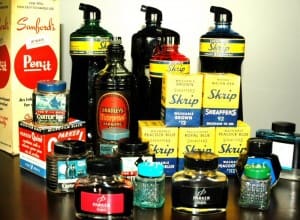 Assorted vintage ink bottles and boxes display.