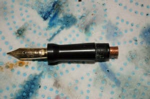 Fountain pen nib on speckled background.