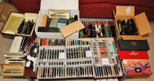 Collection of various pens in boxes.