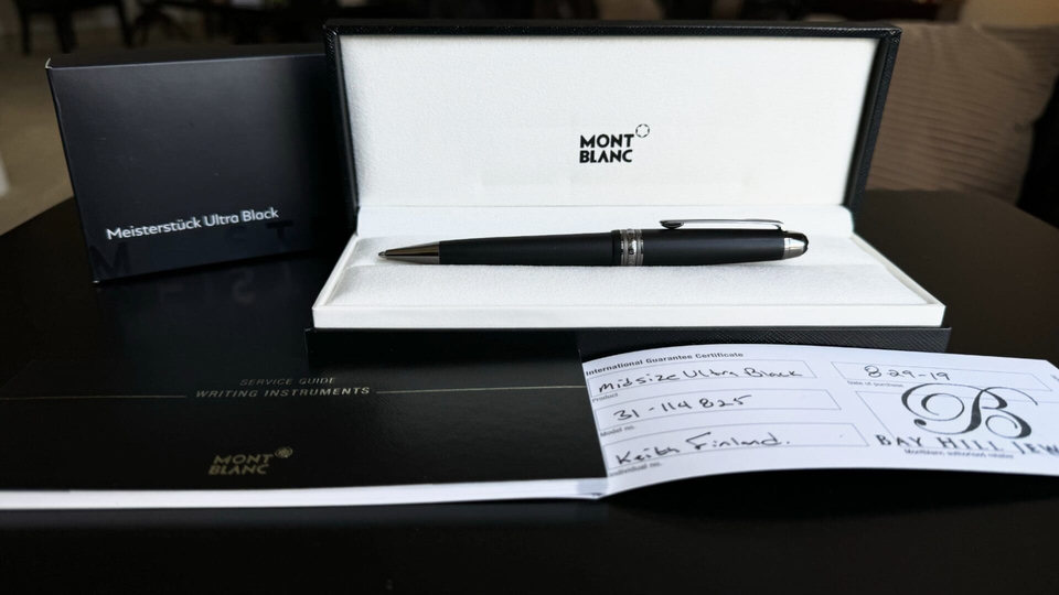 Montblanc pen in open box with documents.