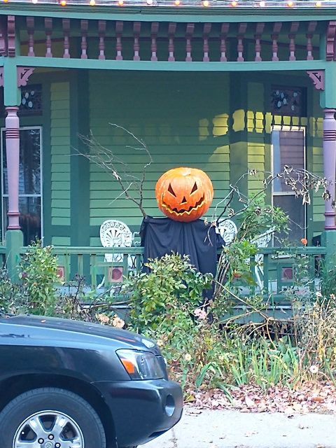 A hand-carved Jack O' Lantern tops a truly creepy scarecrow at an old house in Norwich, Connecticut.